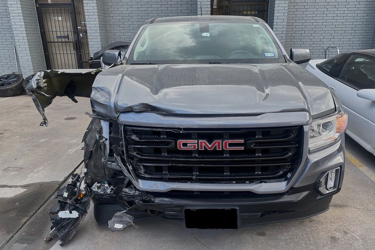 Before collision damage front view truck awaiting body repair