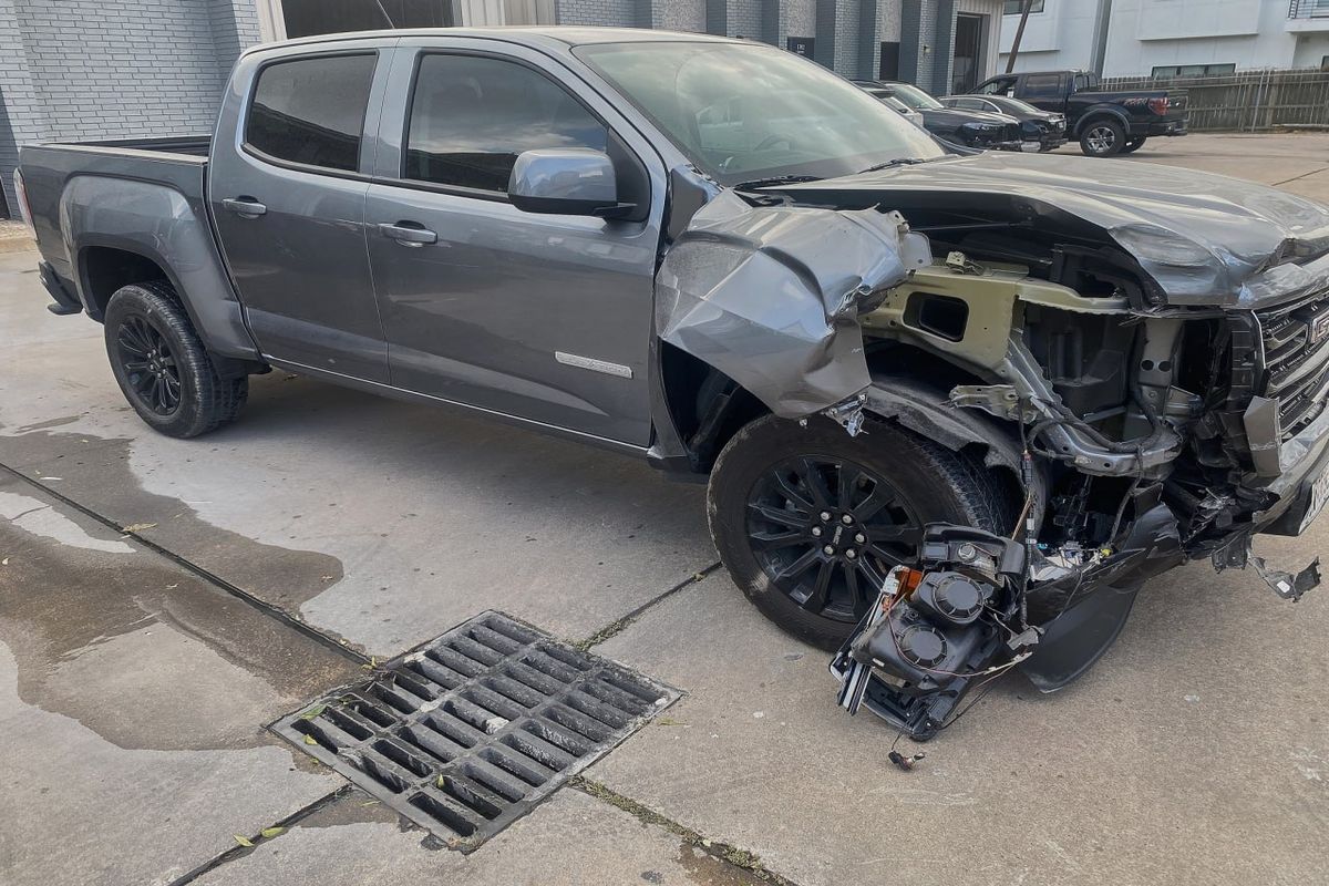 Before collision damage front-quarter view truck in Houston body shop