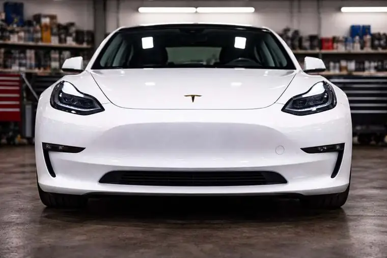 Tesla repair Houston white Tesla in service bay